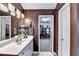 Well-lit bathroom with a vanity, a mirror, and an entry to the walk-in closet at 2695 Ridge Run Trl, Duluth, GA 30097