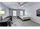Bright bedroom featuring a ceiling fan, two windows, and a desk at 2695 Ridge Run Trl, Duluth, GA 30097
