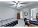 Simple bedroom with a ceiling fan, a desk, and a door to the outside at 2695 Ridge Run Trl, Duluth, GA 30097