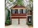 Charming two-story home with red siding, black shutters, and a two-car garage at 2695 Ridge Run Trl, Duluth, GA 30097