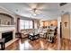 Open-concept living room with a cozy fireplace, hardwood floors, and lots of natural light at 2695 Ridge Run Trl, Duluth, GA 30097