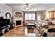 Open-concept living room with a cozy fireplace, hardwood floors, and lots of natural light at 2695 Ridge Run Trl, Duluth, GA 30097