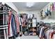 Organized walk-in closet featuring hanging rods and storage shelves for clothes and shoes at 2695 Ridge Run Trl, Duluth, GA 30097
