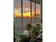 Cozy balcony overlooking a vibrant sunrise, framed by indoor plants and natural light at 3060 Pharr Court N N Ct # 607, Atlanta, GA 30305