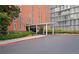 A well-maintained building exterior with a covered entrance and manicured landscaping at 3060 Pharr Court N N Ct # 607, Atlanta, GA 30305