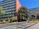 Brick building surrounded by lush trees and manicured landscaping, enhancing curb appeal at 3060 Pharr Court N N Ct # 607, Atlanta, GA 30305