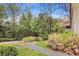 Well-manicured landscaping with flowering bushes and trees along a pathway at 3060 Pharr Court N N Ct # 607, Atlanta, GA 30305