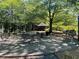 Relaxing outdoor patio area with patio furniture and grilling stations amidst mature trees at 3060 Pharr Court N N Ct # 607, Atlanta, GA 30305