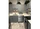 Modern kitchen with stainless steel appliances, light gray cabinets, white countertops and marble-style flooring at 3060 Pharr N Ct # 607, Atlanta, GA 30305