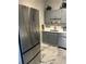 Modern kitchen featuring stainless steel appliances, light gray cabinets, white countertops and marble-style flooring at 3060 Pharr N Ct # 607, Atlanta, GA 30305