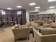 Cozy library with armchairs, tables, and floor-to-ceiling bookshelves filled with books at 3060 Pharr N Ct # 607, Atlanta, GA 30305