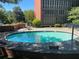 Community pool surrounded by brick wall and greenery, perfect for a refreshing swim at 3060 Pharr N Ct # 607, Atlanta, GA 30305