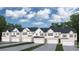Newly constructed townhomes feature white facades, stone accents, and individual garages at 3084 Yellowhammer Dr, Marietta, GA 30064