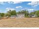 A large backyard featuring a newly renovated two-story house with a red door at 565 Deer Sw Run, Lilburn, GA 30047