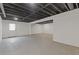 Spacious unfinished basement with exposed ceiling, painted brick walls and concrete floors at 565 Deer Sw Run, Lilburn, GA 30047