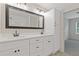 Bathroom boasts a dual sink vanity, large mirror, and a separate room with modern fixtures at 565 Deer Sw Run, Lilburn, GA 30047