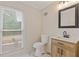 Renovated bathroom with modern vanity, sleek fixtures, and marble-look flooring at 565 Deer Sw Run, Lilburn, GA 30047