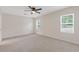 Spacious bedroom with neutral walls, plush carpeting, and natural light from two windows at 565 Deer Sw Run, Lilburn, GA 30047