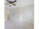 Bedroom featuring neutral walls, plush carpeting, and bright closet space at 565 Deer Sw Run, Lilburn, GA 30047