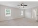 Large bedroom featuring neutral walls, plush carpeting, and natural light from windows at 565 Deer Sw Run, Lilburn, GA 30047