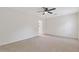 Spacious bedroom with neutral walls, plush carpeting, and bright entrance to the bathroom at 565 Deer Sw Run, Lilburn, GA 30047