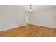 Bright dining room featuring hardwood floors, a modern chandelier, and neutral paint at 565 Deer Sw Run, Lilburn, GA 30047