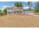Charming two-story home with a bright red front door and covered porch at 565 Deer Sw Run, Lilburn, GA 30047
