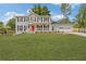 Charming two-story home with a bright red front door and covered porch at 565 Deer Sw Run, Lilburn, GA 30047