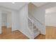 Hallway with hardwood floors and a carpeted staircase at 565 Deer Sw Run, Lilburn, GA 30047
