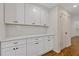 Updated kitchen with white cabinets, quartz countertops, and subway tile backsplash at 565 Deer Sw Run, Lilburn, GA 30047