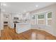 Bright kitchen with stainless steel appliances, white cabinets, and hardwood floors at 565 Deer Sw Run, Lilburn, GA 30047