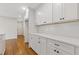 Bright kitchen features white cabinets, quartz countertops, and a subway tile backsplash at 565 Deer Sw Run, Lilburn, GA 30047