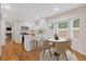 Sunlit kitchen with stainless appliances, quartz counters, and an adjacent dining area at 565 Deer Sw Run, Lilburn, GA 30047