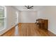 Spacious living room with hardwood floors, natural light, and a piano at 565 Deer Sw Run, Lilburn, GA 30047