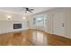 Bright living room with hardwood floors, fireplace, and bay window at 565 Deer Sw Run, Lilburn, GA 30047