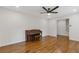 Spacious living room with hardwood floors and a classic piano at 565 Deer Sw Run, Lilburn, GA 30047