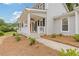 Covered front porch with white railings and ceiling fan at 565 Deer Sw Run, Lilburn, GA 30047