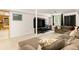 Basement living room featuring a large sectional sofa, mounted TV, and an open layout with carpeting at 922 Barton Woods Ne Rd, Atlanta, GA 30307