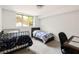 Bedroom featuring two beds, a desk, and natural light streaming through the window at 922 Barton Woods Ne Rd, Atlanta, GA 30307