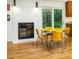 Inviting dining area next to the kitchen area features retro yellow furniture and a brick fireplace at 922 Barton Woods Ne Rd, Atlanta, GA 30307