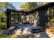 View of the outdoor deck area with black painted stairs and siding with many windows at 922 Barton Woods Ne Rd, Atlanta, GA 30307
