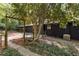 A black house with a small fence, concrete path, and natural landscaping at 922 Barton Woods Ne Rd, Atlanta, GA 30307