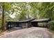 A modern single-story house with a carport nestled among leafy trees at 922 Barton Woods Ne Rd, Atlanta, GA 30307