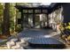 View of the outdoor deck area with black painted stairs and siding with door and windows at 922 Barton Woods Ne Rd, Atlanta, GA 30307
