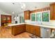 Bright kitchen area boasts wood cabinets, white countertops, stainless steel appliances, and access to dining area at 922 Barton Woods Ne Rd, Atlanta, GA 30307