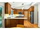Charming kitchen with wood cabinets, stainless steel appliances, and peninsula with white countertop at 922 Barton Woods Ne Rd, Atlanta, GA 30307