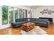 Bright living room with hardwood floors, large windows, and a stylish gray sectional sofa at 922 Barton Woods Ne Rd, Atlanta, GA 30307
