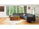 Bright living room with hardwood floors and a large sectional sofa and view of wooded back yard at 922 Barton Woods Ne Rd, Atlanta, GA 30307