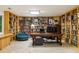 Home office with custom bookshelves spanning the walls, a large desk, and comfortable seating area at 922 Barton Woods Ne Rd, Atlanta, GA 30307