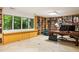 Spacious home office featuring custom built-in shelving, a large desk, and natural light from surrounding windows at 922 Barton Woods Ne Rd, Atlanta, GA 30307